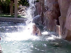 Adorable blonde in a skimpy bikini gives an outdoor blowjob