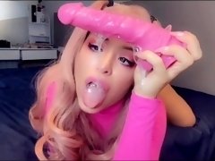doll plays with a rubber cock