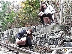 Friends piss by the railroad tracks